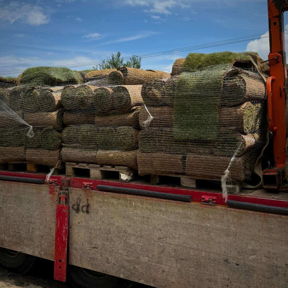 Import of carpet lawn to the garden from Dream Garden - a truck brings in a grass carpet for immediate laying and landscaping of the exterior