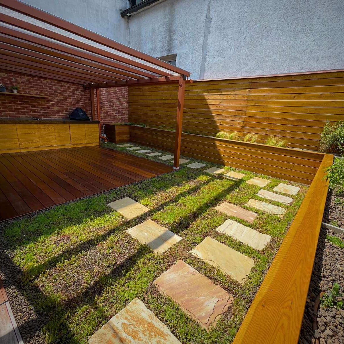 Outdoor terrace with ornamental plantings from Dream Garden - a modern outdoor space for relaxation and dining